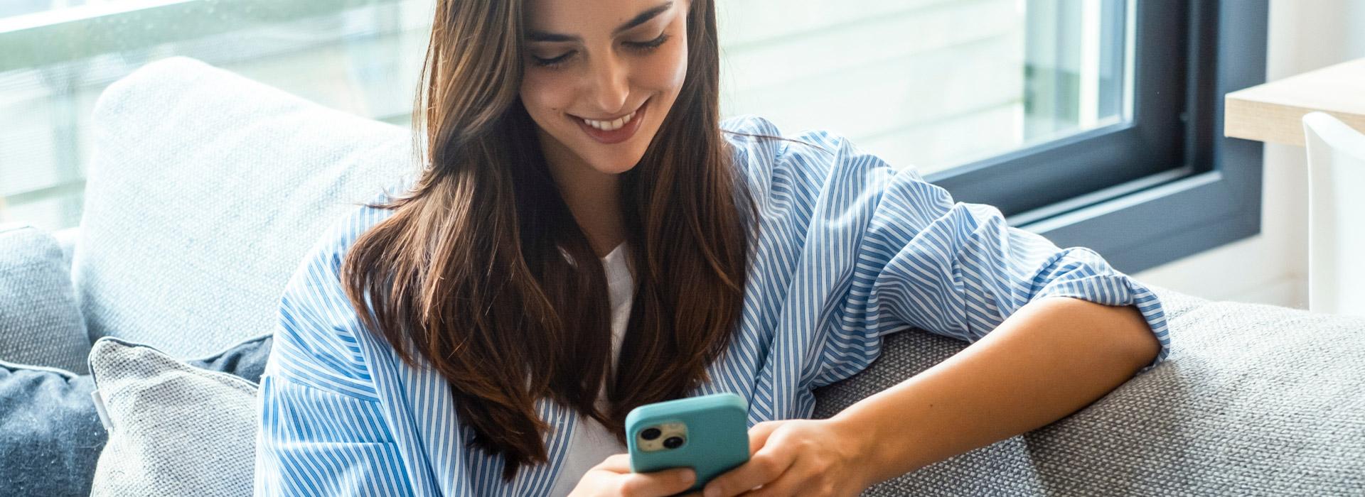 lady sitting on couch texting