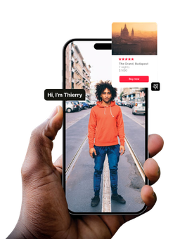 Hand holding smartphone displaying a person in orange jacket on street with travel app interface