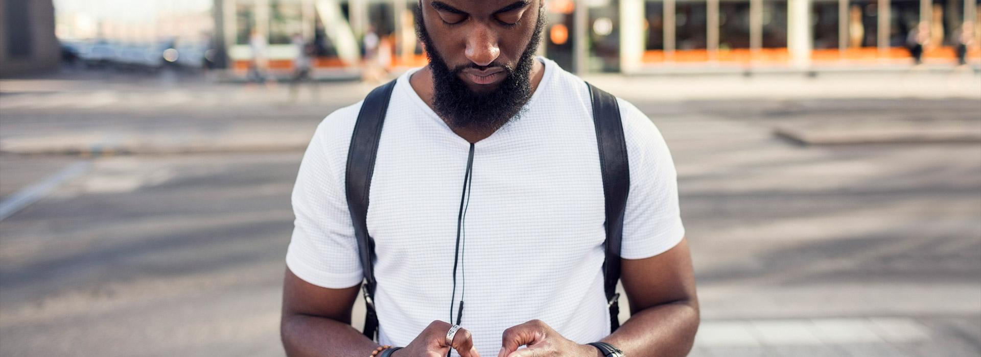 African American man texting on his cellphone